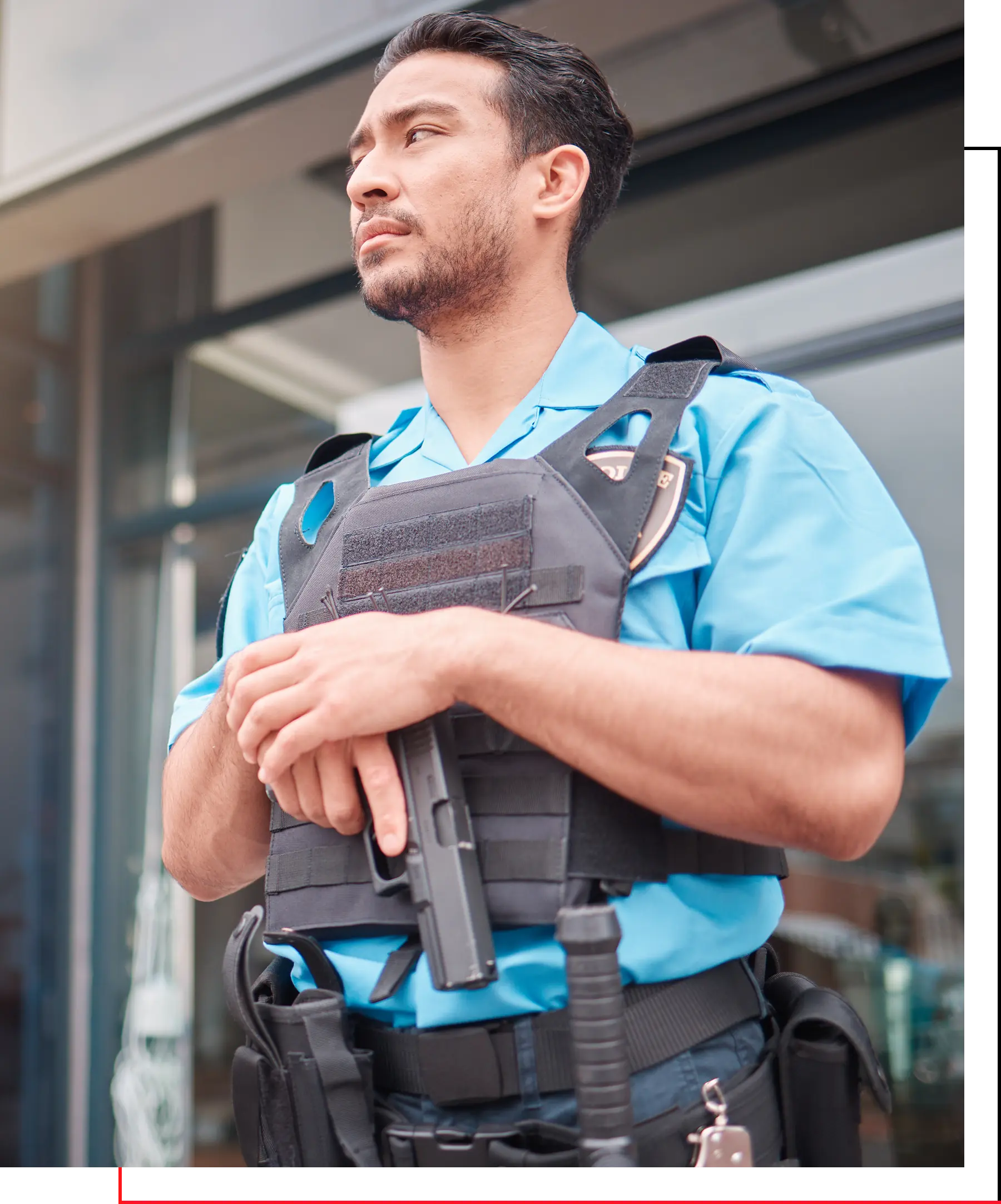 A man in blue shirt holding a gun.